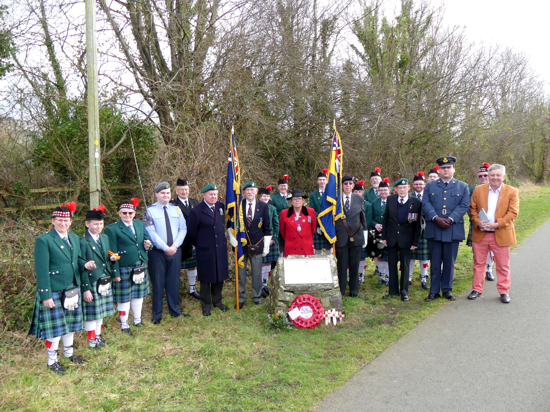 The group gathers for a picture at the memorial site. Credit: Graham Hobbs