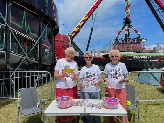 Three members of Soroptimist International Barnstaple and District, the Oceanfest last month, handing out bags of drink spiking deterrents to festival-goers. Credit: Barnstaple Soroptimists