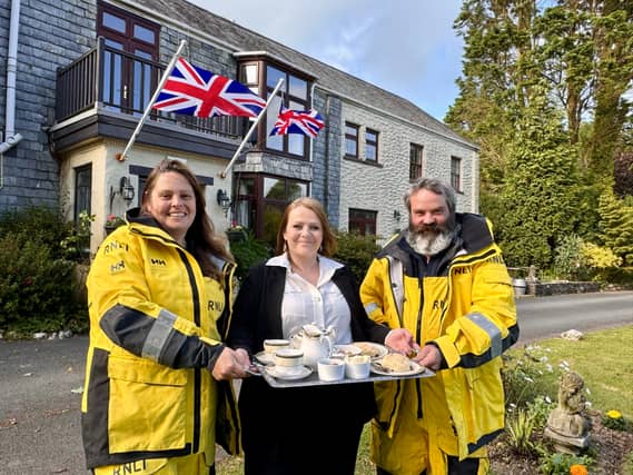 Ilfracombe RNLI crew Gillian Cole and Stuart Carpenter join Trimstone Manor’s Rhianne Mockridge to encourage people to go along for the RNLI Charity Cream Tea this June. Credit: Trimstone