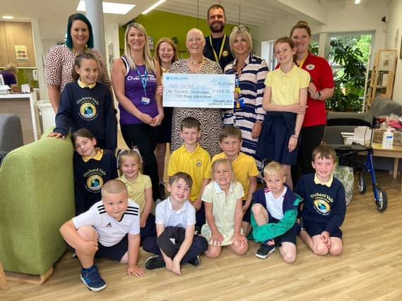 Sue Manley and Orchard Vale staff and pupils visit the Over and Above Fern Centre following the school’s ‘Crazy Hair Day’ fundraiser. Credit: Over and Above
