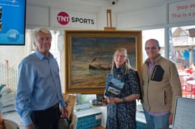 Michael Lees with his painting of the Jane Hannah Macdonald III alongside author Annemarie Munro and John Vistuer, who bought the painting. 