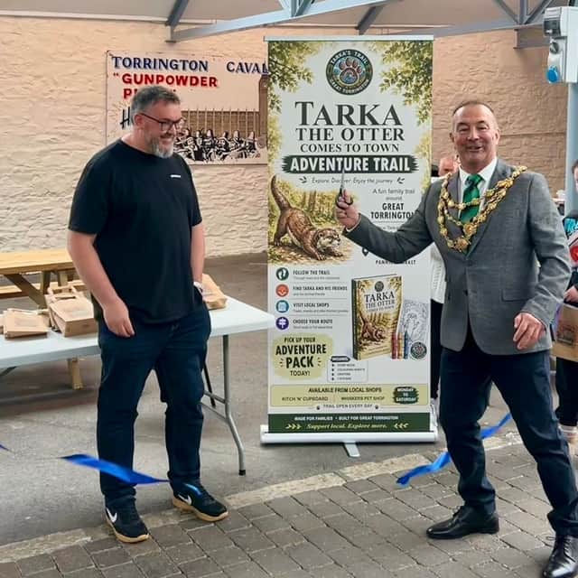 Torrington Mayor, Councillor Dave Parish, cuts the ribbon alongside Cllr Jason Isaac to declare the Tarka Comes To Town trail officially open.