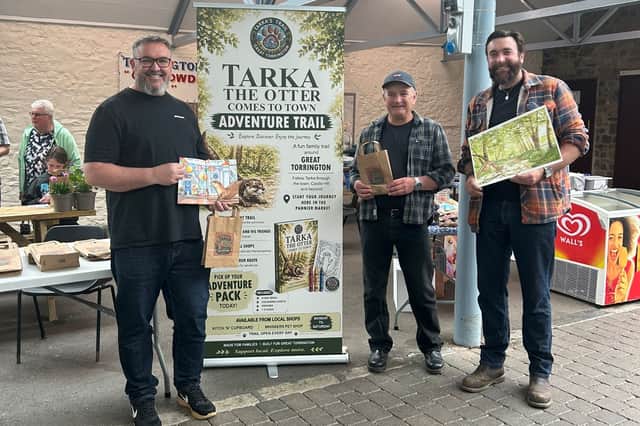 Trail creator Jason Isaac (left) with trail book artist Joseph Witchall and chainsaw artist Brendan Knott, who created the sculptures.