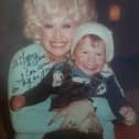 Dolly Parton hugs a young Sam Butler after her secret visit to Manaton in 1979 