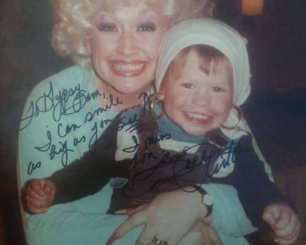 Dolly Parton hugs a young Sam Butler after her secret visit to Manaton in 1979 