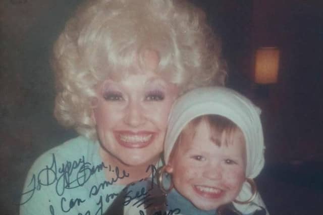 Dolly Parton hugs a young Sam Butler after her secret visit to Manaton in 1979