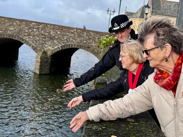 Irene Hockin, president of Barnstaple Soroptimists, scattering petals on the Taw last year in memory of domestic abuse victims, pictured with ye then mayor, Councillor Janet Coates and local police commander Superintendent Emma Butler-Jones. Credit: Viral PR