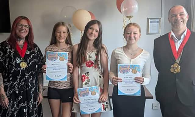 Barnstaple Carnival Royalty winners Abigail Williams, Molly-Rose Browning and Gracie Roper receive their certificates from Barnstaple Mayor Cllr Loki Dawson and mayoress Emma Skinner.