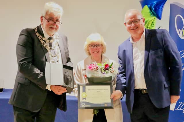 Gloria Satchwell is presented with her Outstanding Contribution to Ilfracombe Award by the Mayor, Mark Fay and North Devon MP Ian Roome. Credit: Ilfracombe Town Council