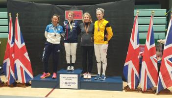 Guildford International Becky Ragland (in yellow) bronze photo @ Gillian Azajghan
