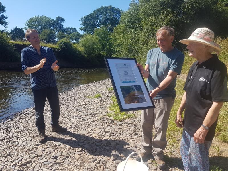 Halsdon and Dolton Local Group’s Diana Goodacre receives her Devon Wildlife Trust fellowship award from Mike Moser while Harry Barton applauds - Credit: Devon Wildlife Trust