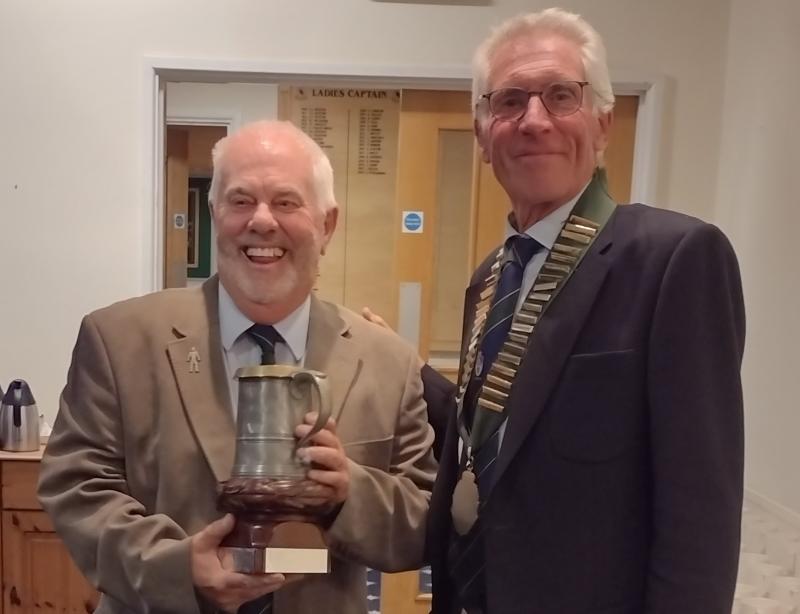 Great Torrington team Captain receiving the Trophy from the DMVGA President Bob Small