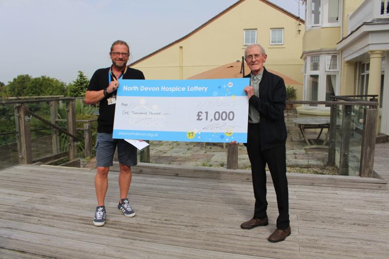 Richard Carter presenting a cheque to one of the hospice's recent lottery winners
