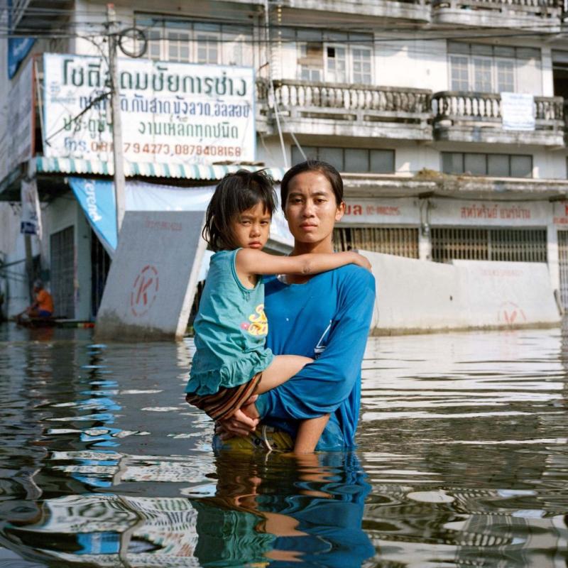 Mum, and child in flood water in Thailand