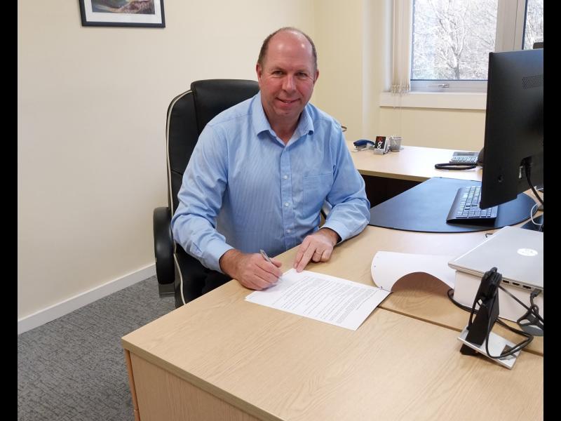 North Devon Homes CEO, Martyn Gimber, signing the contract to join the partnership - Credit: NDH