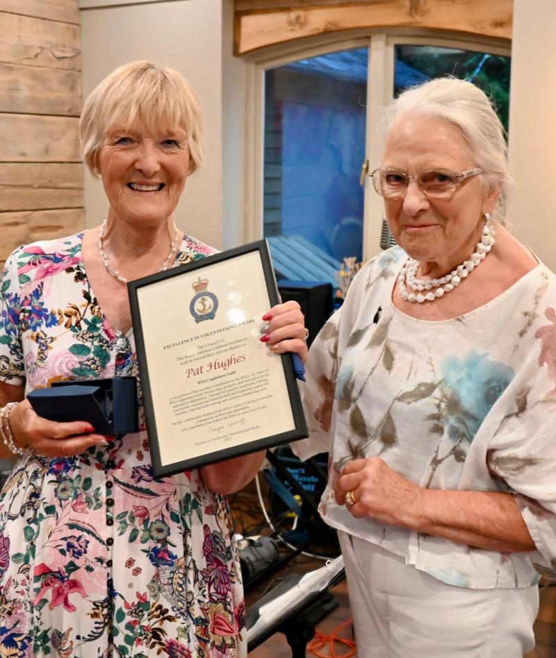 Pat Hughes (left) presented with the RNLI Excellence in Volunteering Award by Julie Turner - Credit: RNLI