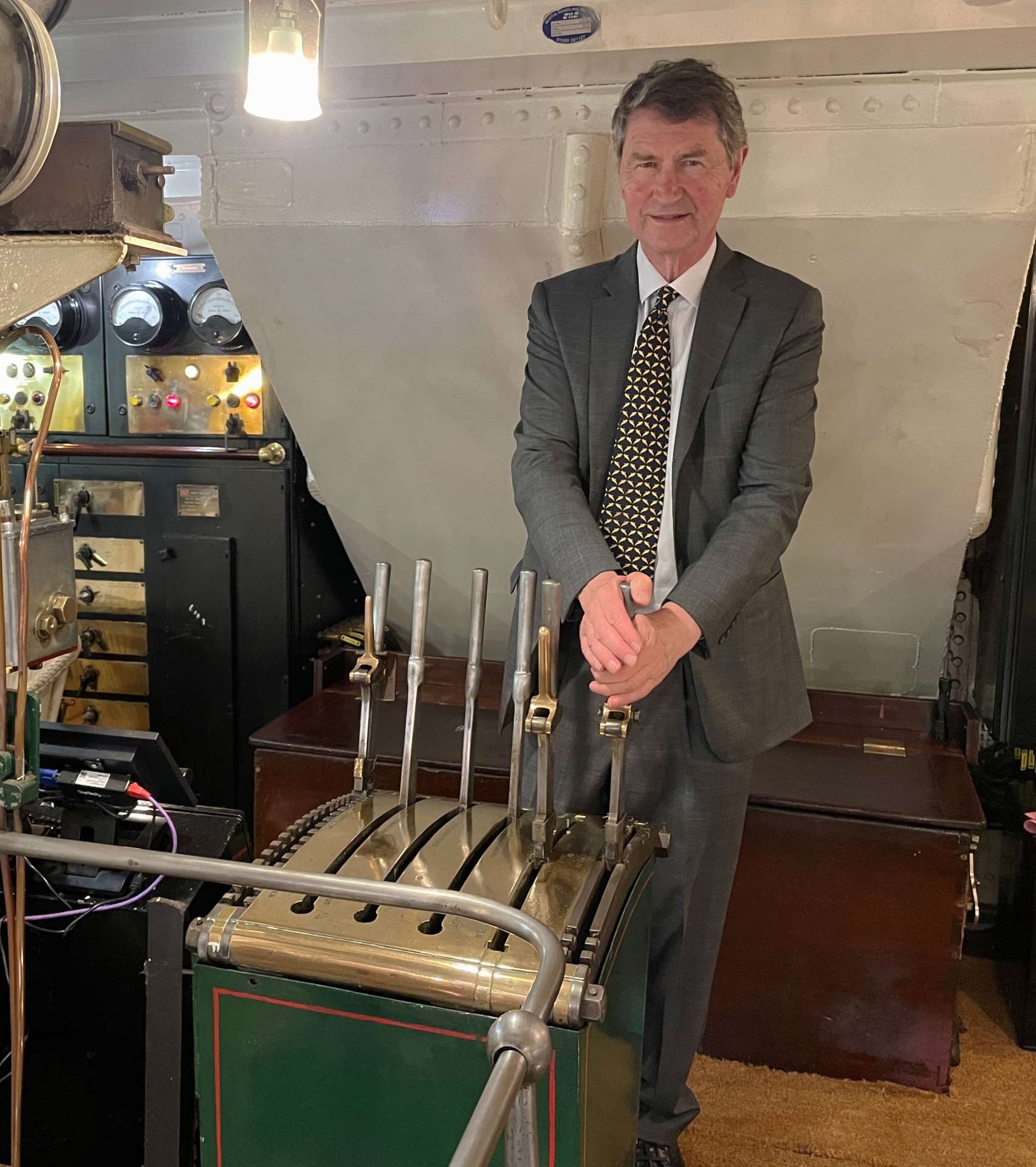 Sir Tim at the control levers in Waverley's engine room - Credit: Waverley Excursions