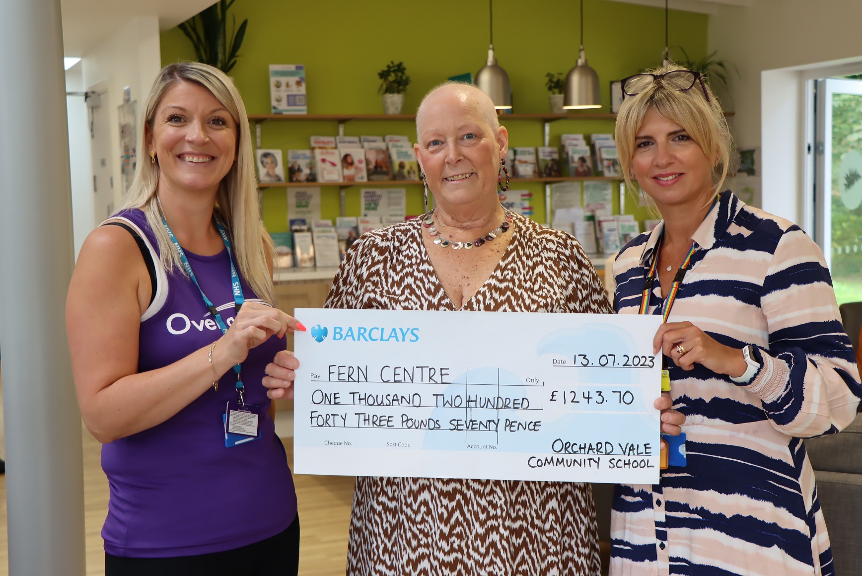 Presenting a cheque for £1,243.70 to Over & Above