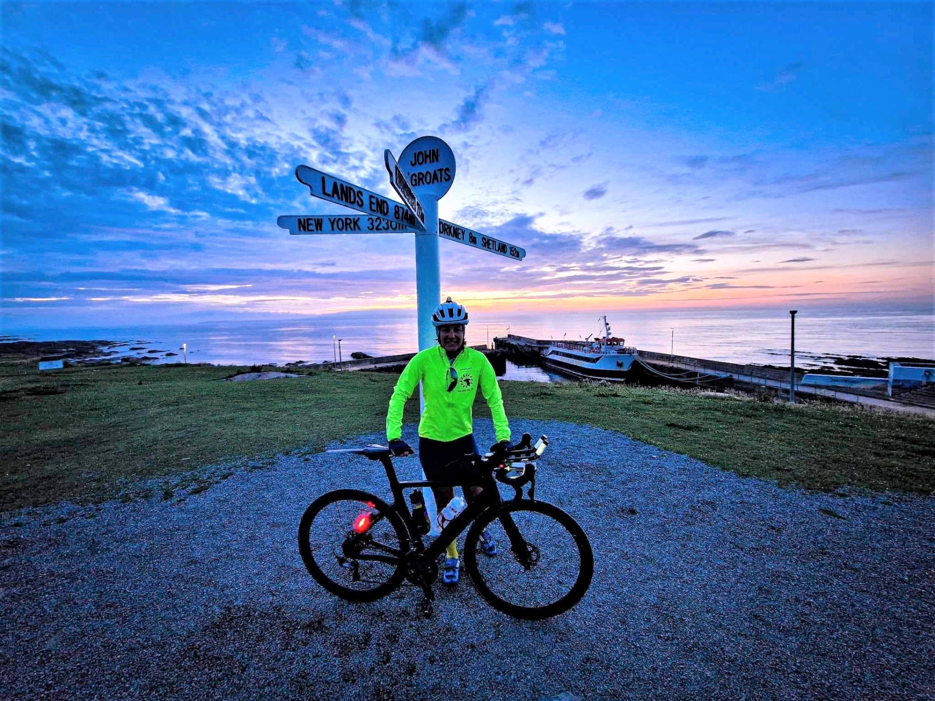 Louise Harris at John O' Groats, the most northerly point on the British mainland, before cycling all the way back to Land's End. Credit: Glyn Brackenbury