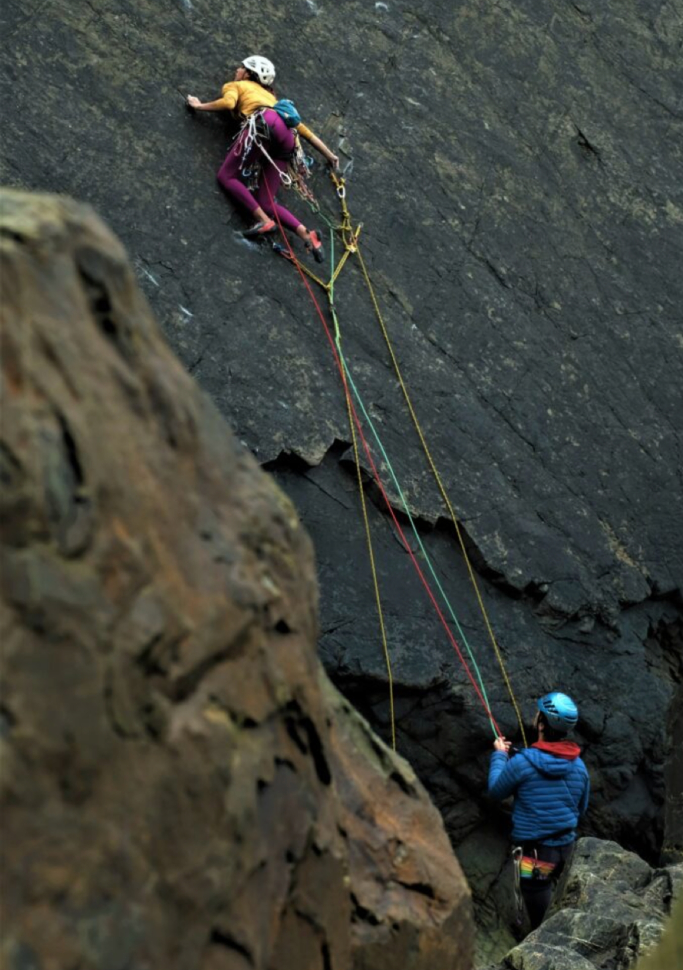 Tom Randall belaying for Anna on the first female ascent of the Slab
