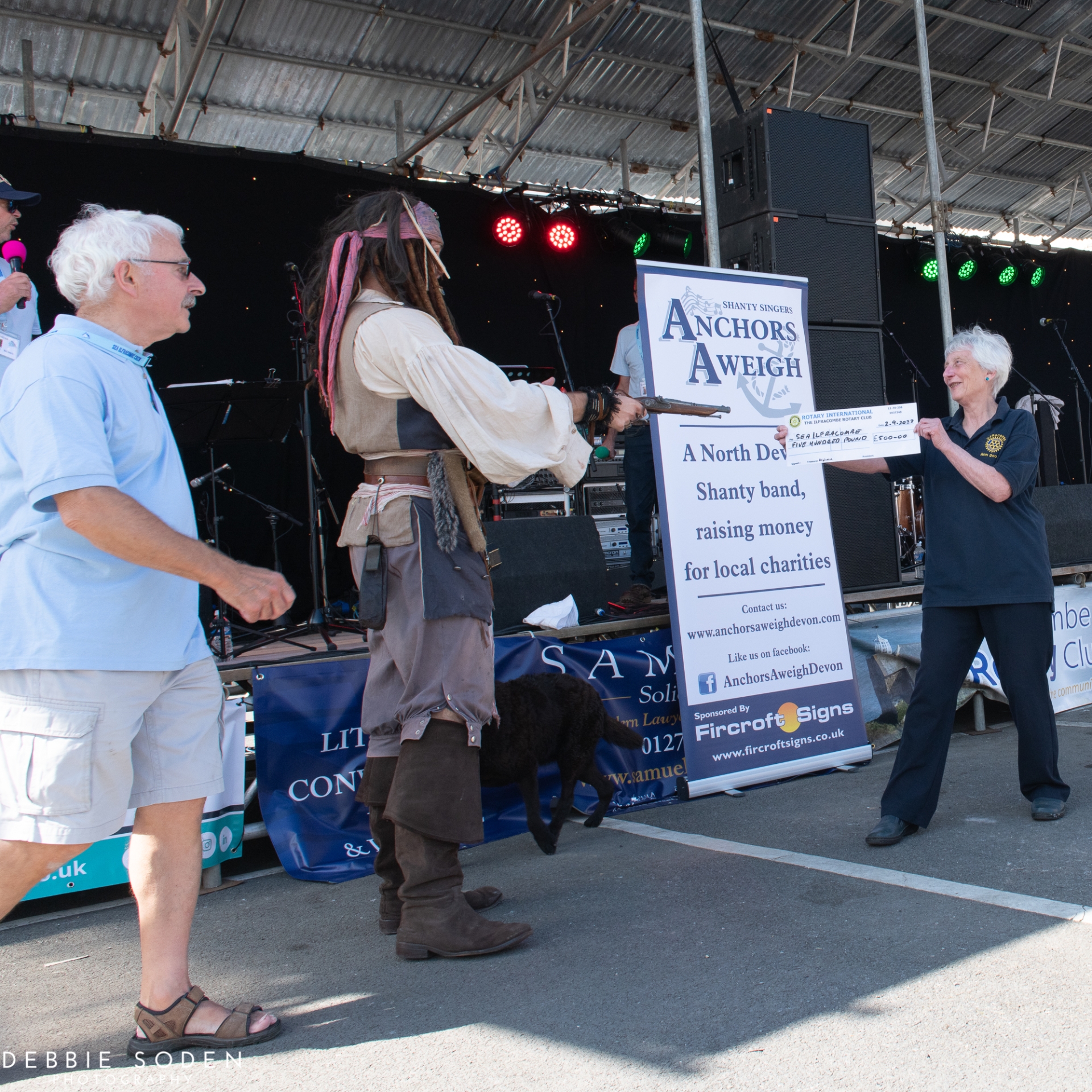 Ann Doody presenting a cheque to an excitable 'Captain Jack Sparrow' during the Sea Ilfracombe Festival.