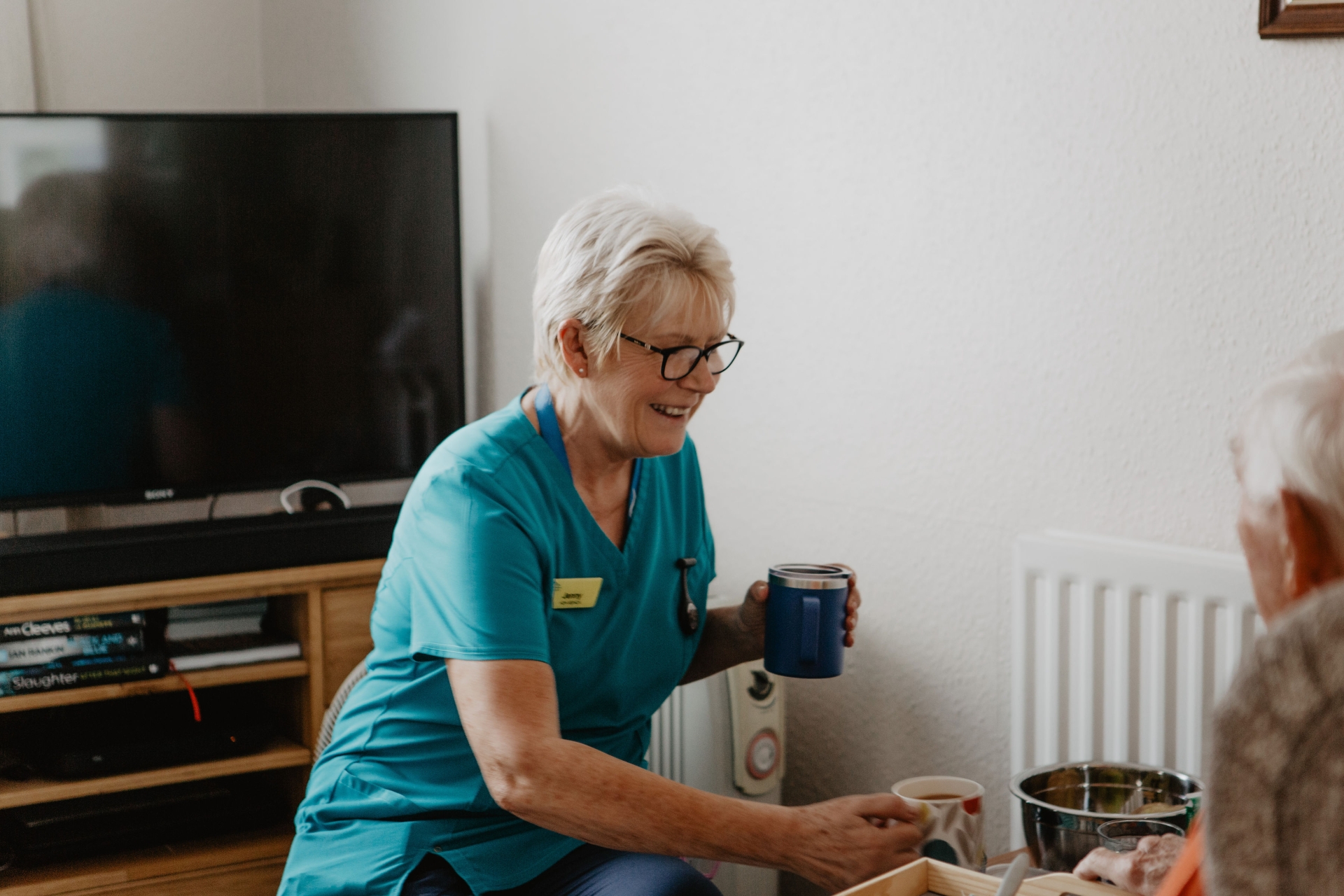 Jenny from the Hospice to Home team helping a patient at home. Credit: Joanna Robb/Sonder West Photography 