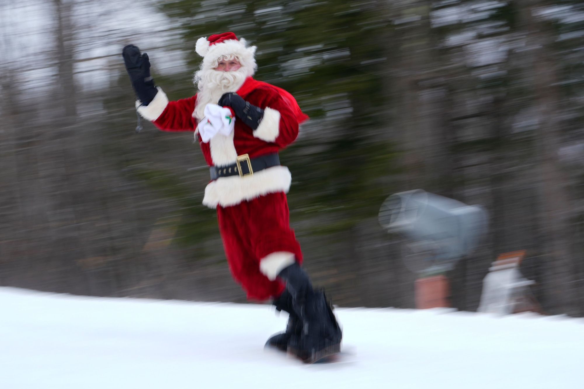 A skier dressed as Santa Claus skis for charity at the Sunday River Ski Resort in Newry, Maine