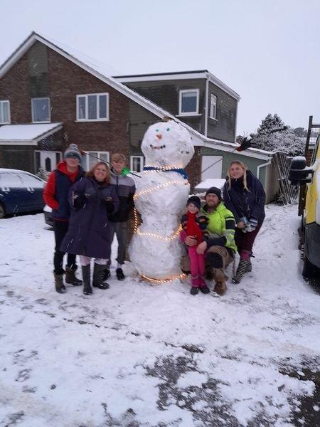 Family fun building a snowman in South Molton. Credit: David Worden
