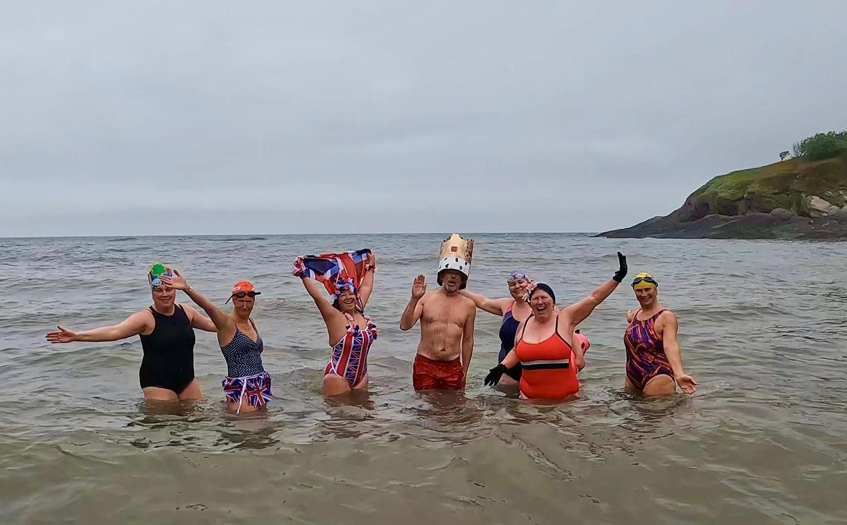 The Hele Bay Merbabes take a coronation dip on Saturday at Hele. Credit: Terri Ingram