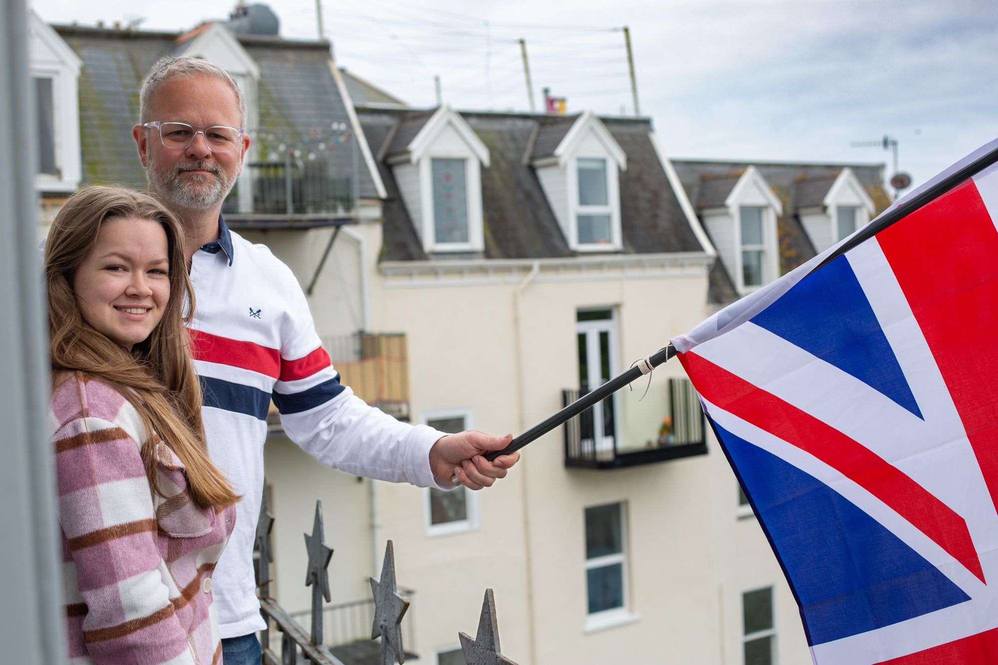 Mark Newland and his daughter flying the flag for Ilfracombe to mark the coronation. Credit: Tim Lamerton